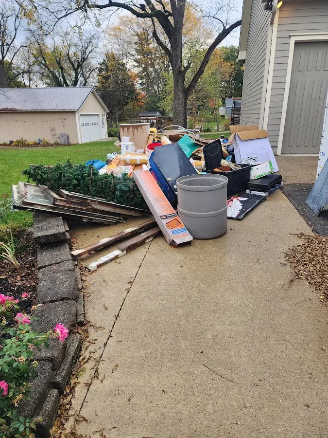 Dumpster being loaded with debris for Roofing Dumpster Rental in Montcalm